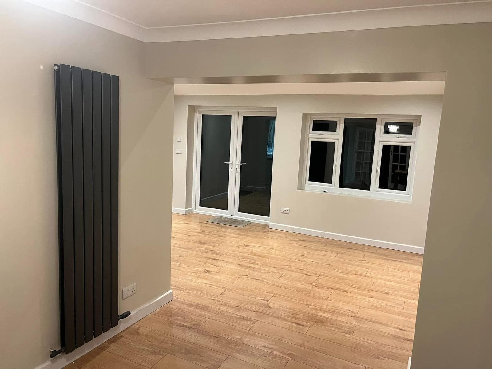 Completed rear extension interior with flooring and vertical radiator
